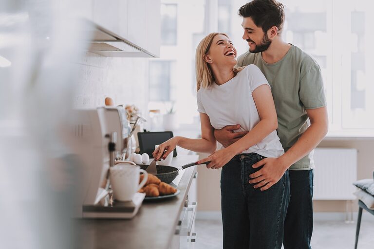 A couple cooking together in a bright Lexington Homes kitchen