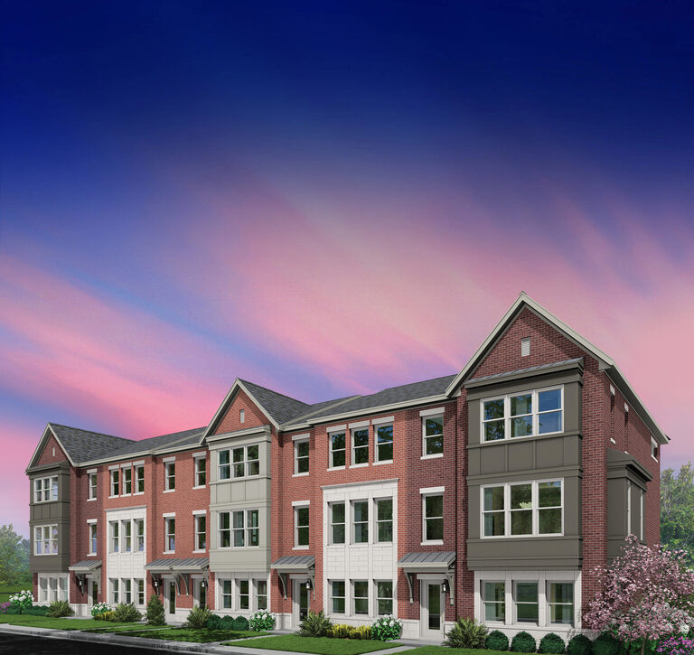 Lexington Homes brick townhomes with landscaped lawns along a neighborhood street at dusk