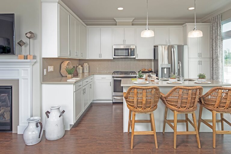 A sunlit open kitchen with a center island inside a Lexington home